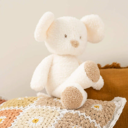Cream mouse plush toy sitting on textured boho cushion, showcasing soft plush texture and tan paw details.
