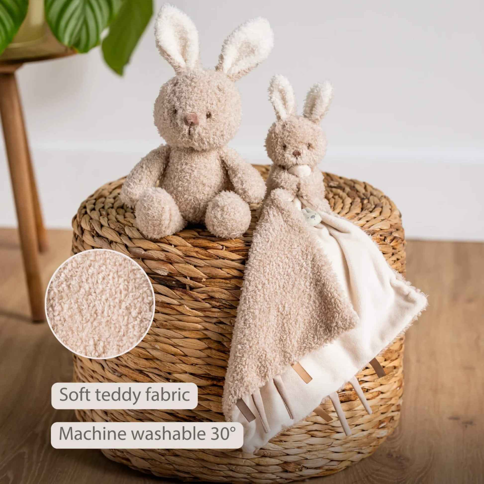 Plush bunny and matching cuddle doudou displayed on a woven basket with a close-up of the teddy fabric texture, shown with the text ‘Soft teddy fabric’ and ‘Machine washable 30°’ on the image.