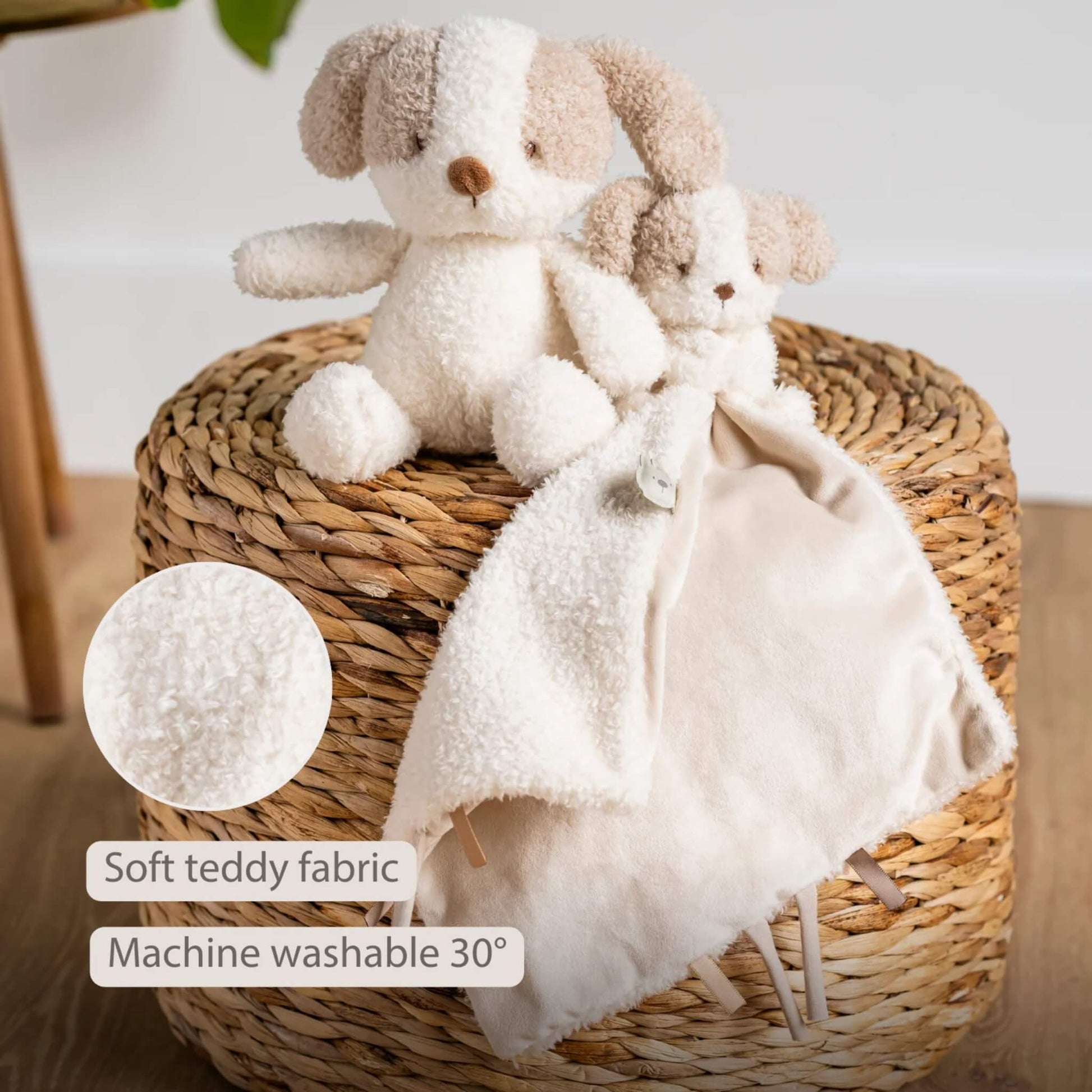 Plush toy dog and matching doudou displayed on a woven surface with a close-up circle showing the teddy fabric texture, shown with the text ‘Soft teddy fabric’ and ‘Machine washable 30°’ on the image.