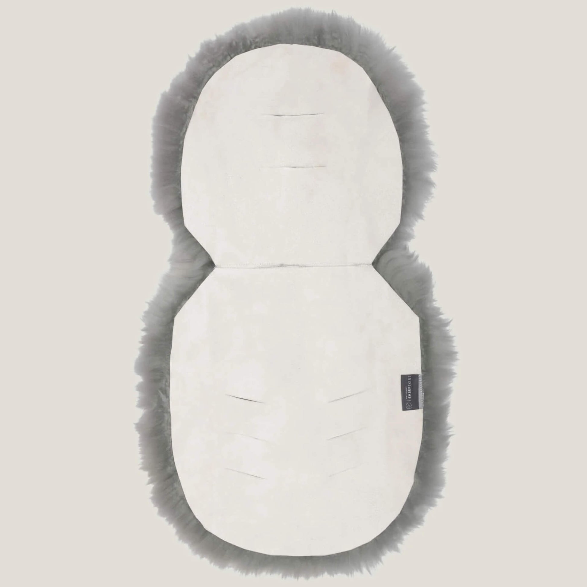Reverse view of grey sheepskin pram liner showing cream suede backing with multiple harness openings.