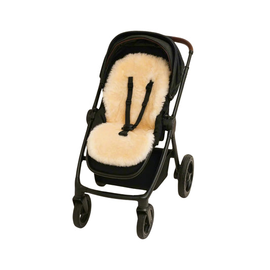 Naturally Sheepskins Snuggly Pram Liner in natural colour fitted into a pushchair, with harness slots visible for secure fitting.