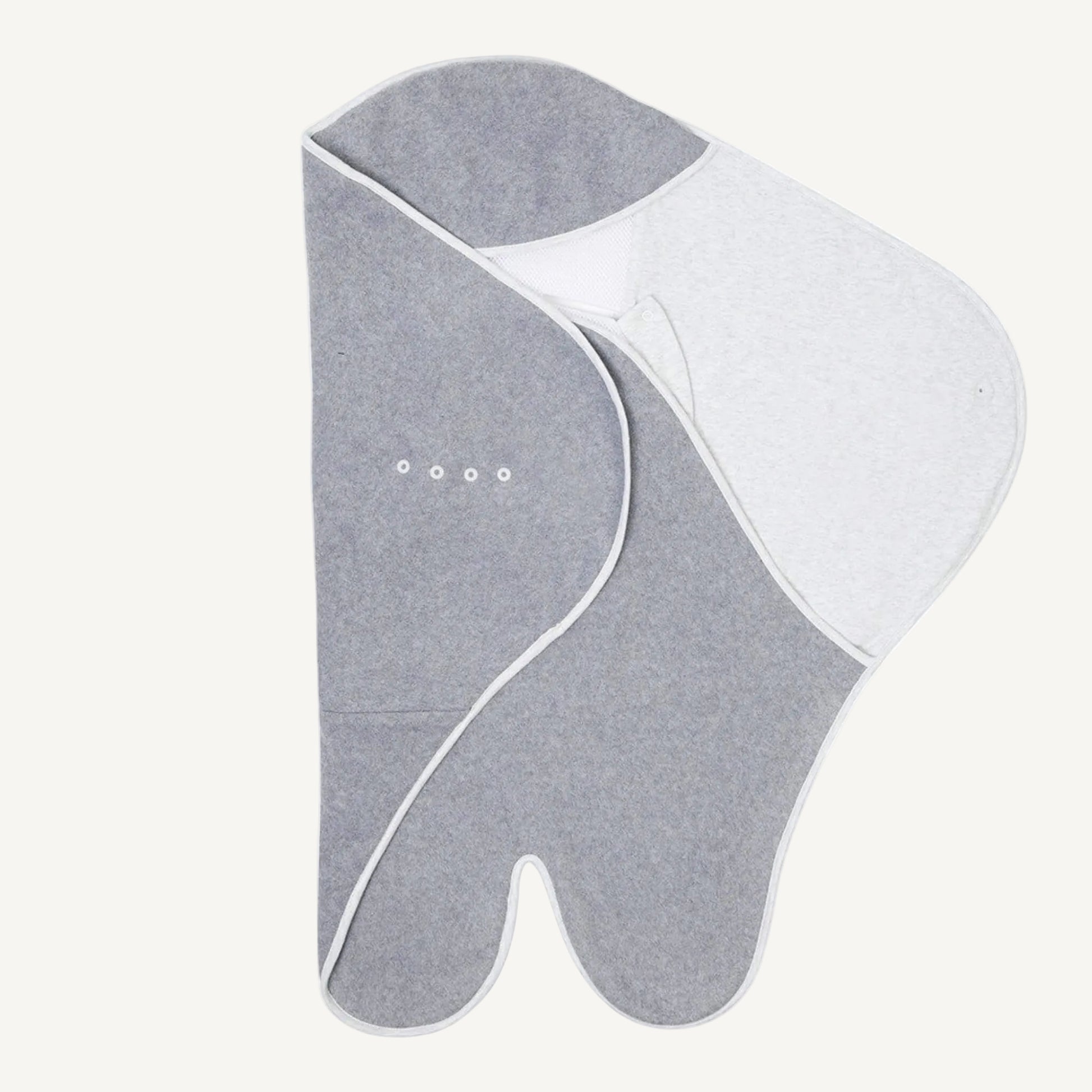 Partially folded travel blanket with darker grey fleece on one side, wing extended on the other and poppers visible.