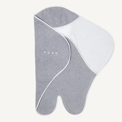 Partially folded travel blanket with darker grey fleece on one side, wing extended on the other and poppers visible.