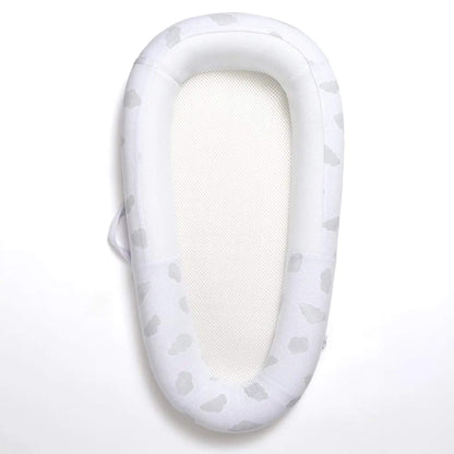 Purflo Sleep Tight Baby Bed in Cotton Clouds design with breathable mesh base and structured padded sides, shown from above.