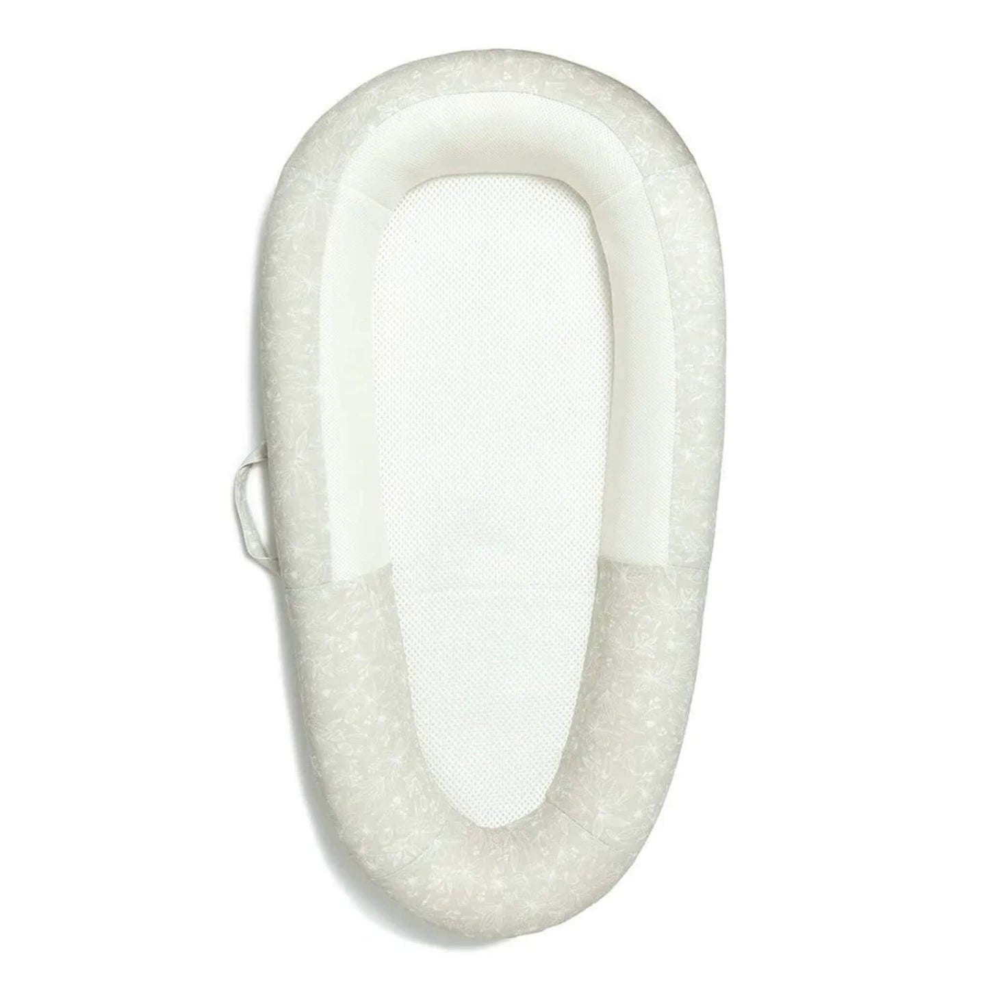 Purflo Sleep Tight Baby Bed, top-down view showing a breathable mesh mattress base and softly structured sides in a pale botanical print.