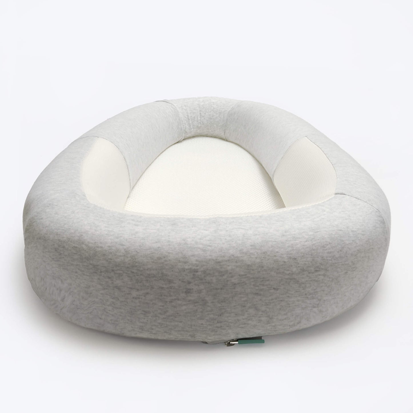 A structured baby bed in soft grey fabric, shown from a low front angle to highlight the cushioned outer shape and mesh sleeping surface.