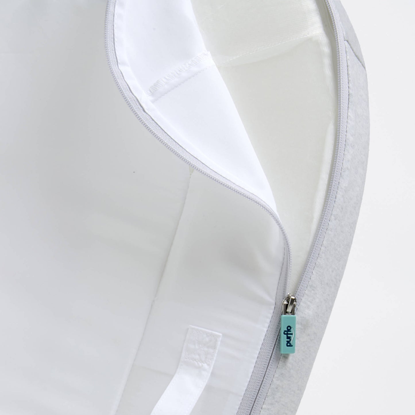 A removable baby bed cover shown partially unzipped, revealing a wipe-clean inner surface and stitched seams.