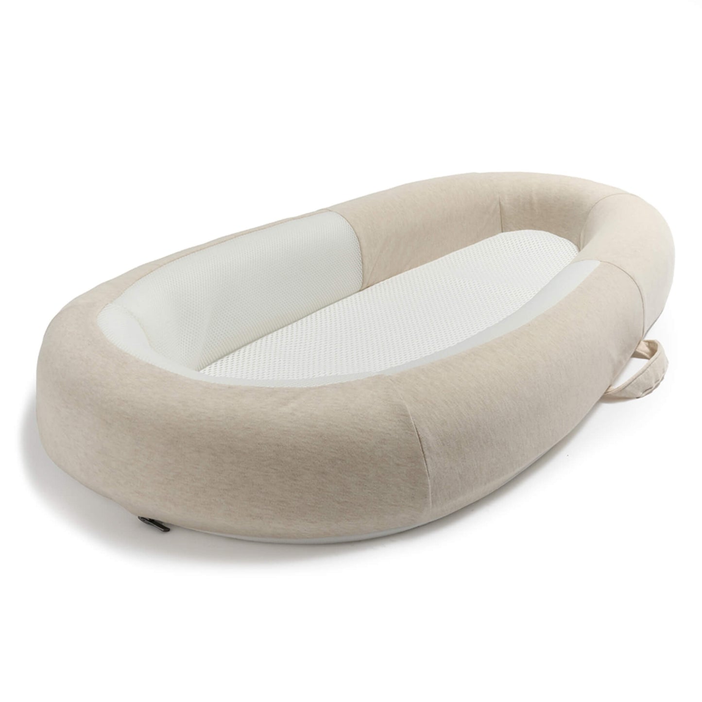 A side view of a baby bed with raised padded sides, breathable mesh lining and a carry handle.