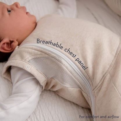 A close-up showing the breathable mesh chest panel and side zip on the Summer Sand swaddle bag while worn by a baby.
