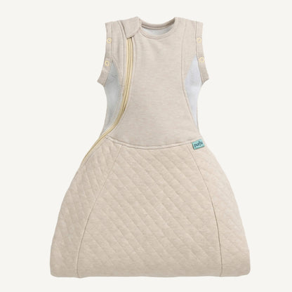 A front view of a beige baby sleep bag showing a curved zip opening and mesh side panels.