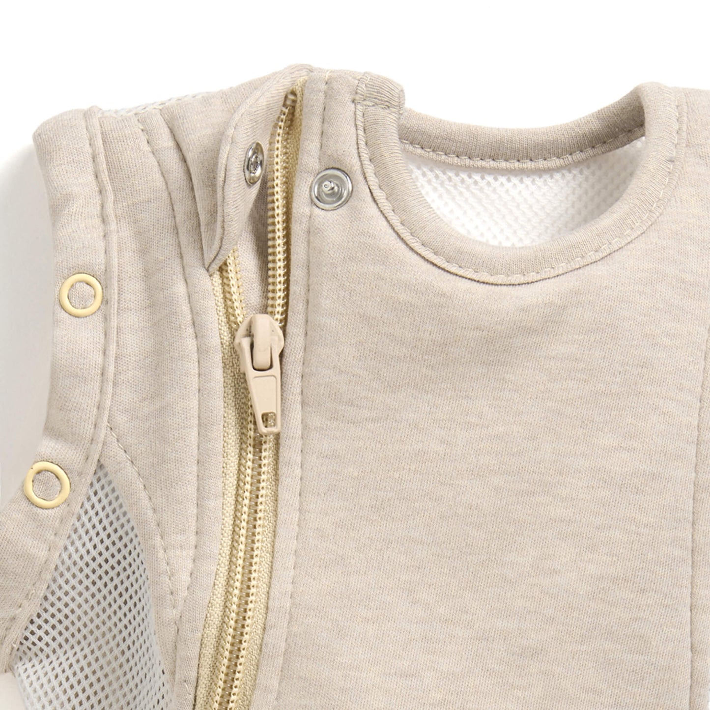 A close-up of a concealed zip with a fabric guard near the neckline of a baby sleep bag.