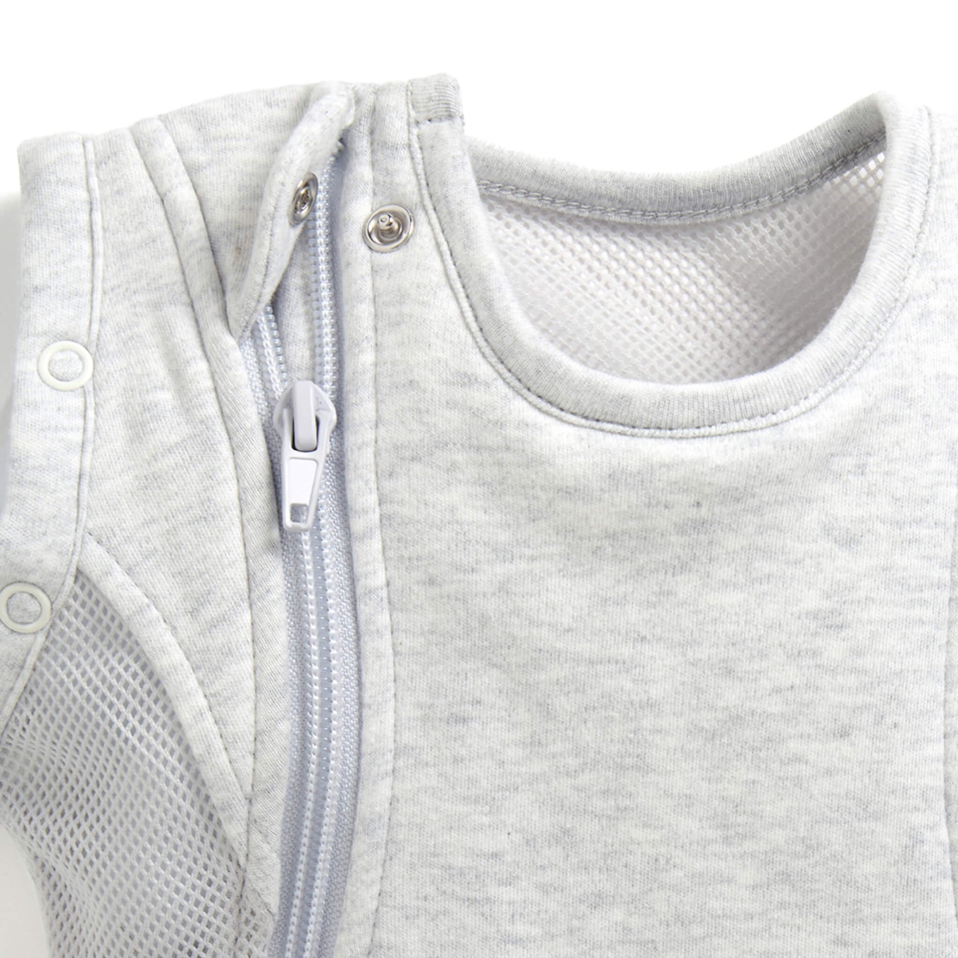 A close-up of the zip opening and shoulder poppers, showing smooth stitching and a soft neckline finish designed for comfort.