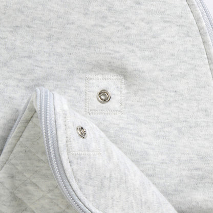 A close-up of the lower section showing quilted padding and internal poppers that allow the sleep bag length to be adjusted as a baby grows.