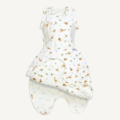 A swaddle to sleep bag opened to show a wrap-style front panel folded back, revealing a lighter inner lining and leg-shaped lower section.