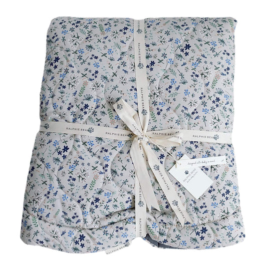 Ralphie Bear quilted baby playmat in Wildflower print with soft padding and stitched finish, folded and tied with branded ribbon, showing cushioned structure and everyday practicality.