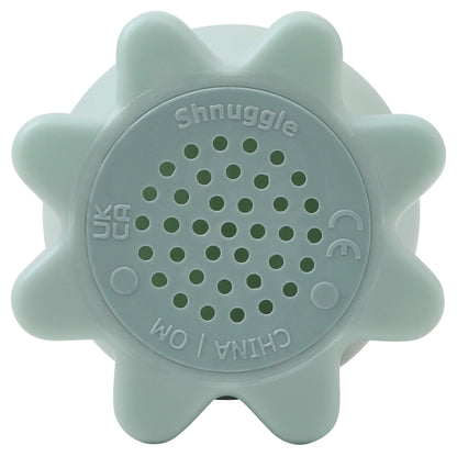The underside of a mint green octopus bath toy, showing a round panel with drainage holes and embossed safety markings.