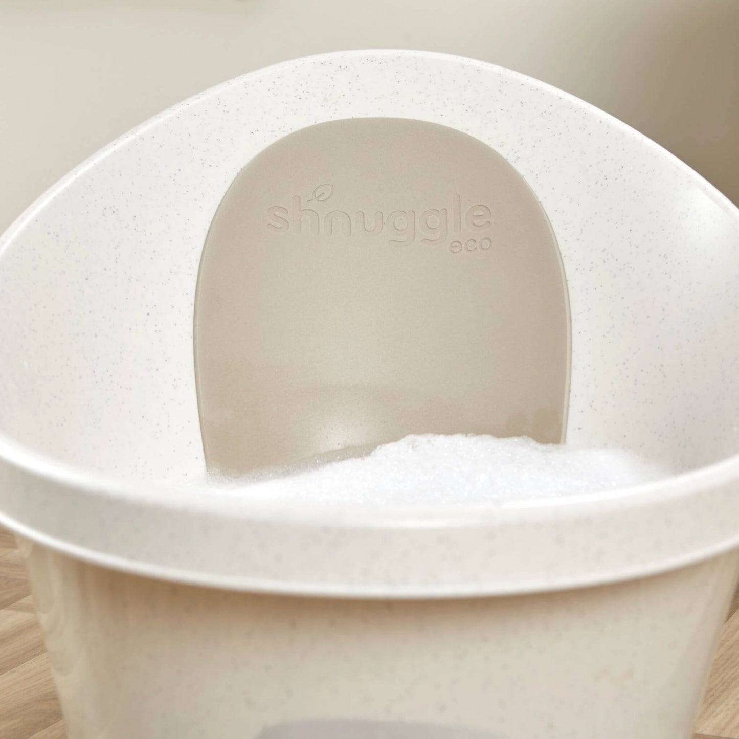 Interior view of a baby bath with soft bubbles inside and an embossed eco back panel.