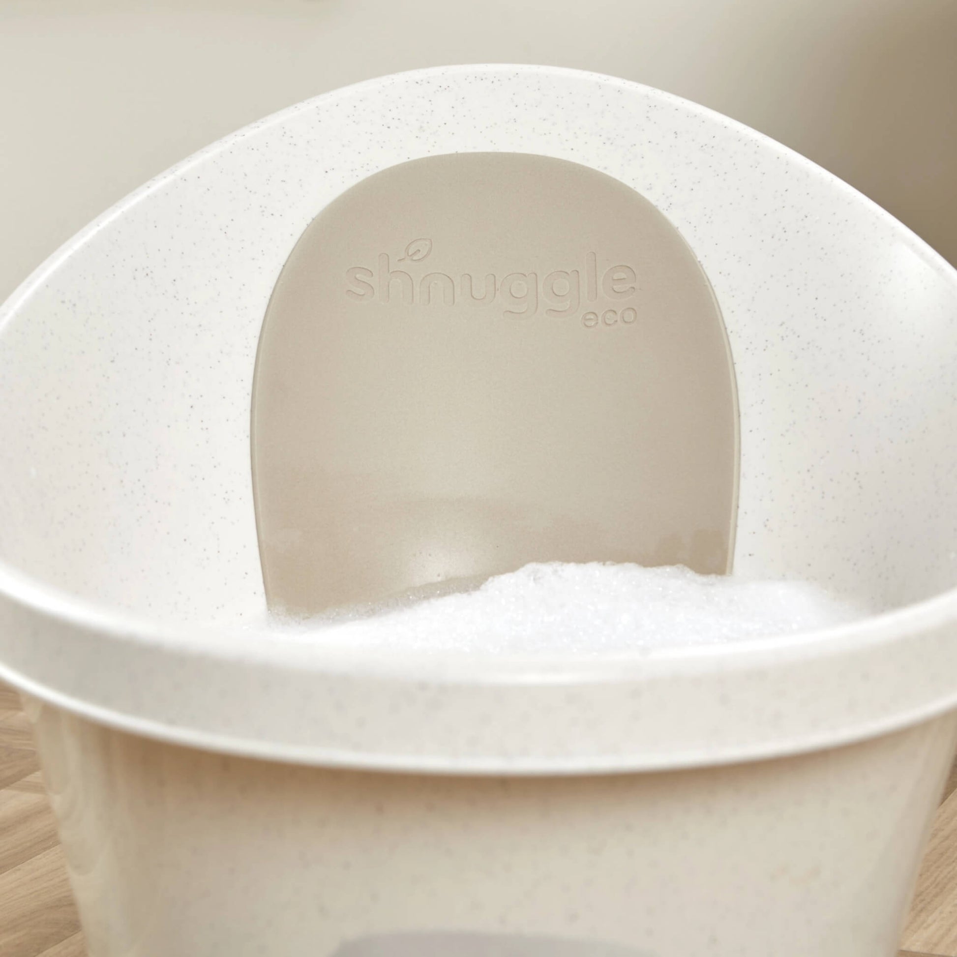 Interior view of a baby bath with soft bubbles inside and an embossed eco back panel.