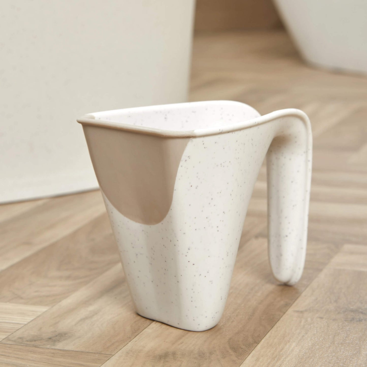 Compact jug with speckled cream design and soft-touch lip, shown from the side.
