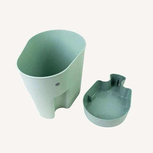 A eucalyptus green elephant bath toy caddy displayed with a separate drip tray placed beside it.