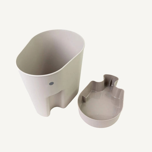 Elephant-shaped bath toy drying caddy in taupe shown beside a matching removable drip tray on a white background.