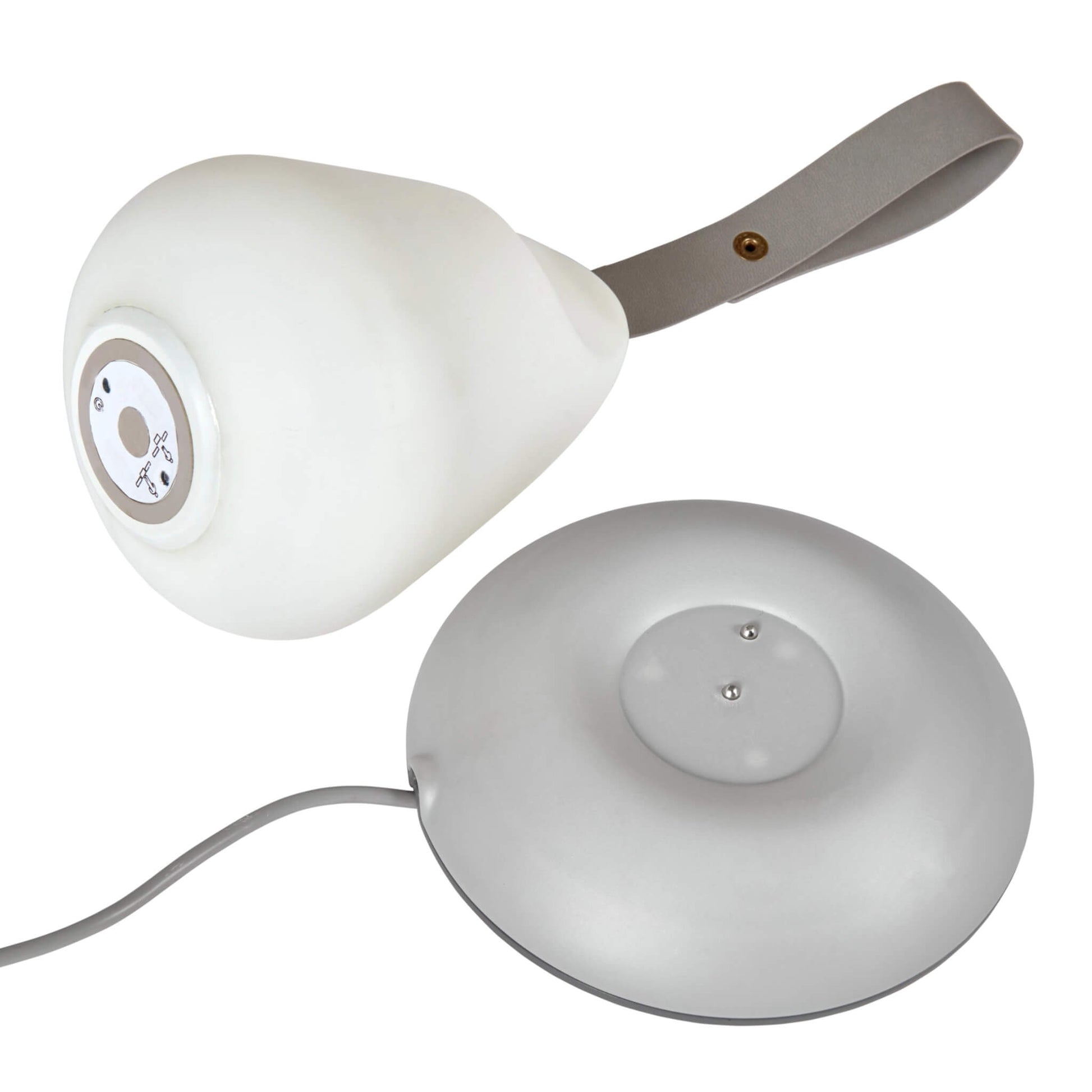Pear-shaped nursery nightlight placed beside its round grey charging base, photographed from above to show the control panel.