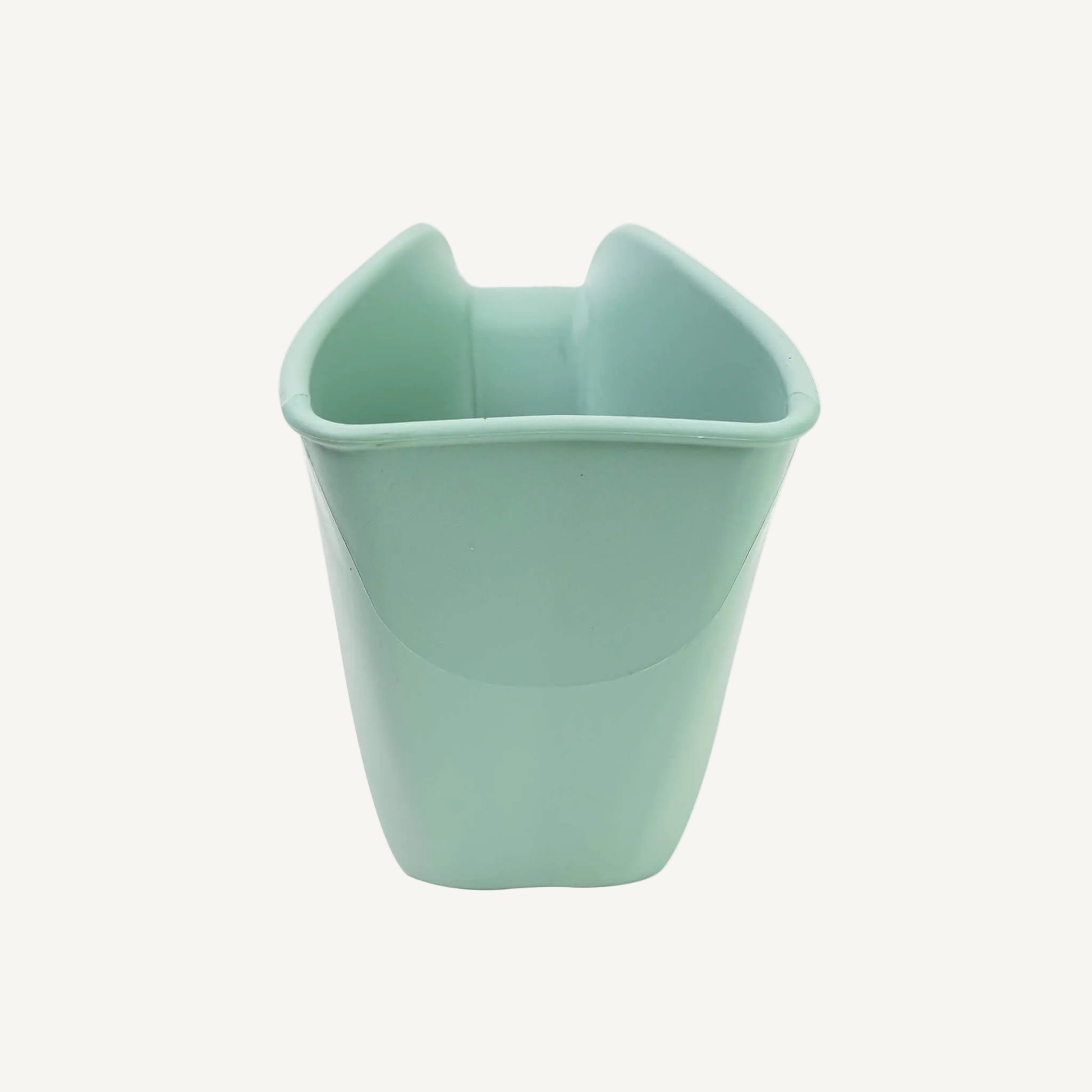 A eucalyptus green rinsing jug shown from the front, showing the wide opening and smooth interior shape for easy pouring.