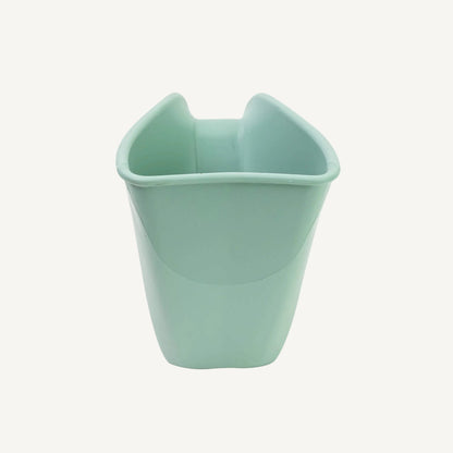 A eucalyptus green rinsing jug shown from the front, showing the wide opening and smooth interior shape for easy pouring.