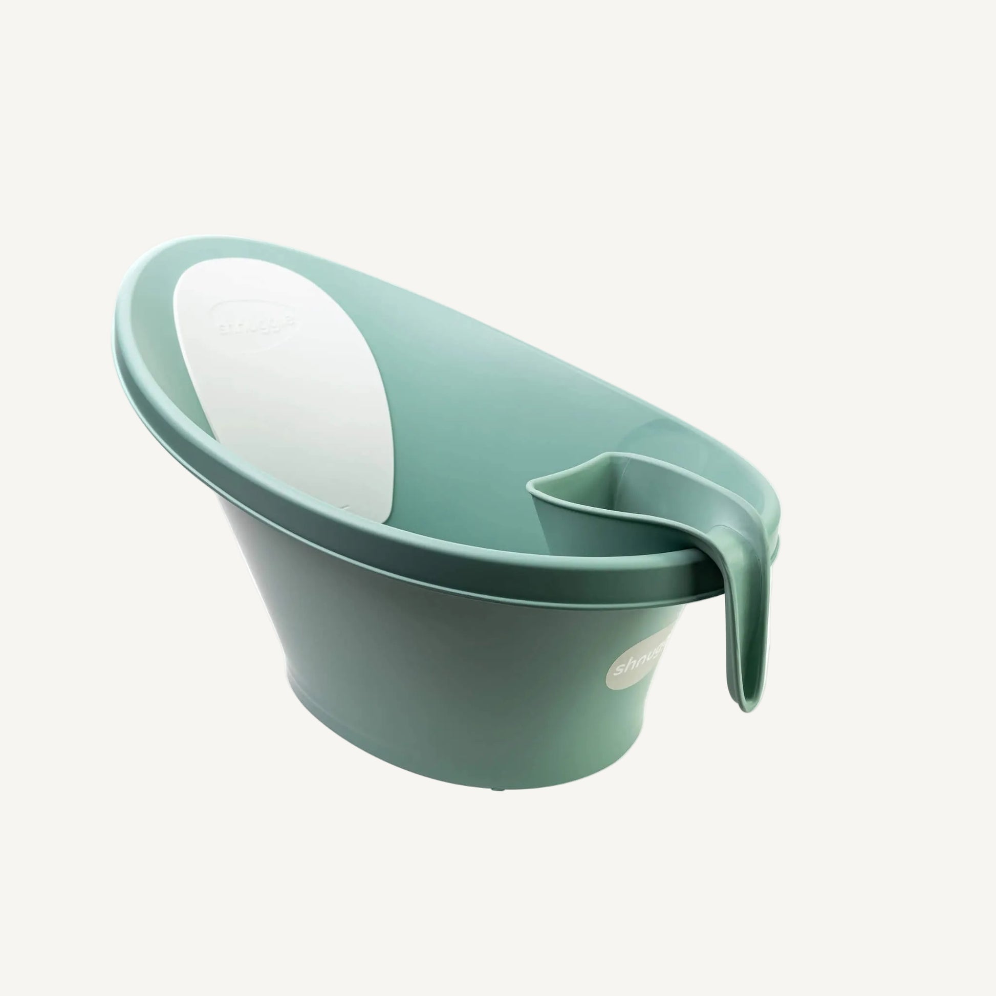 A eucalyptus green rinsing jug hooked onto the rim of a baby bath, showing compact storage within easy reach during bath time.