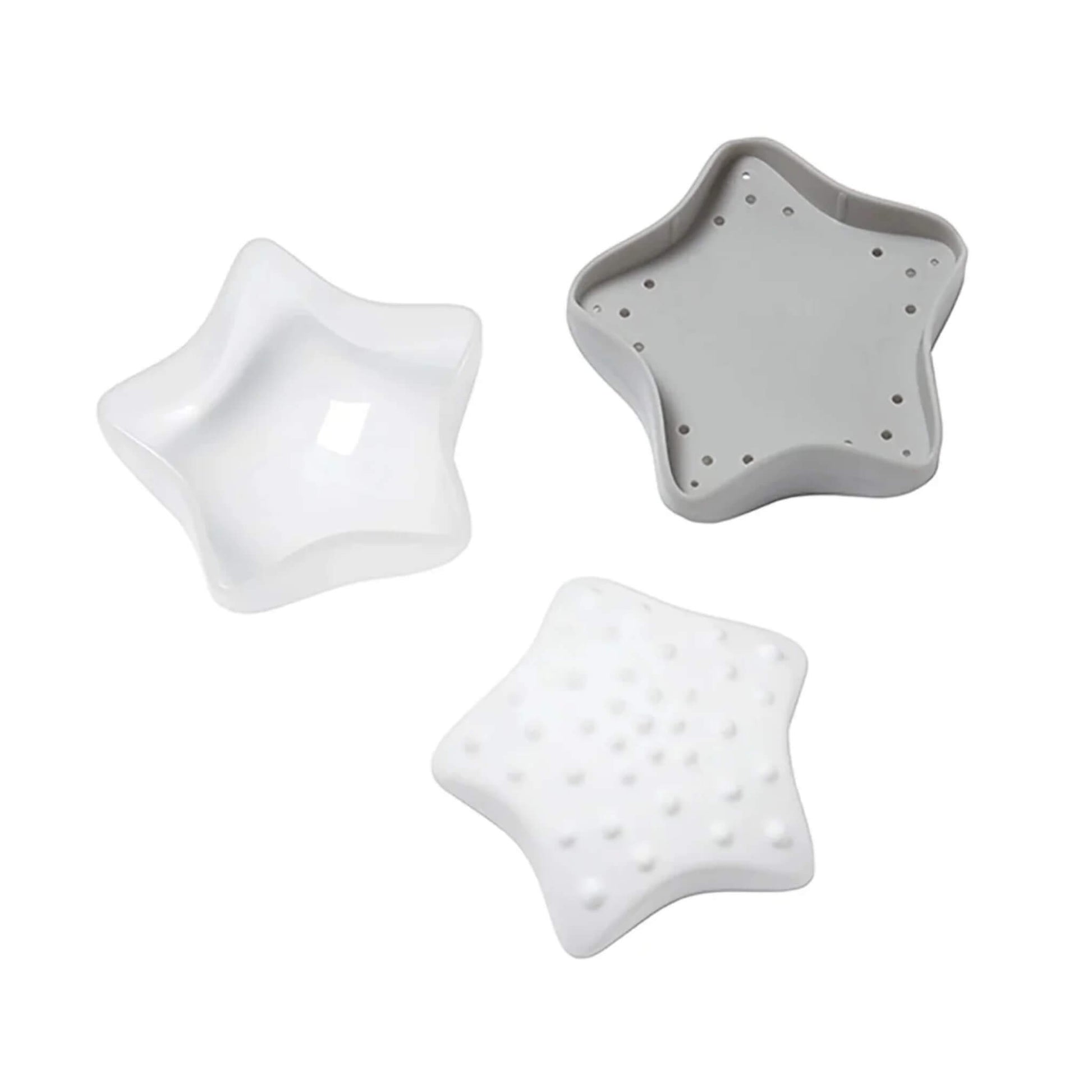 The underside of a star-shaped bath toy showing small drainage holes around the edge.