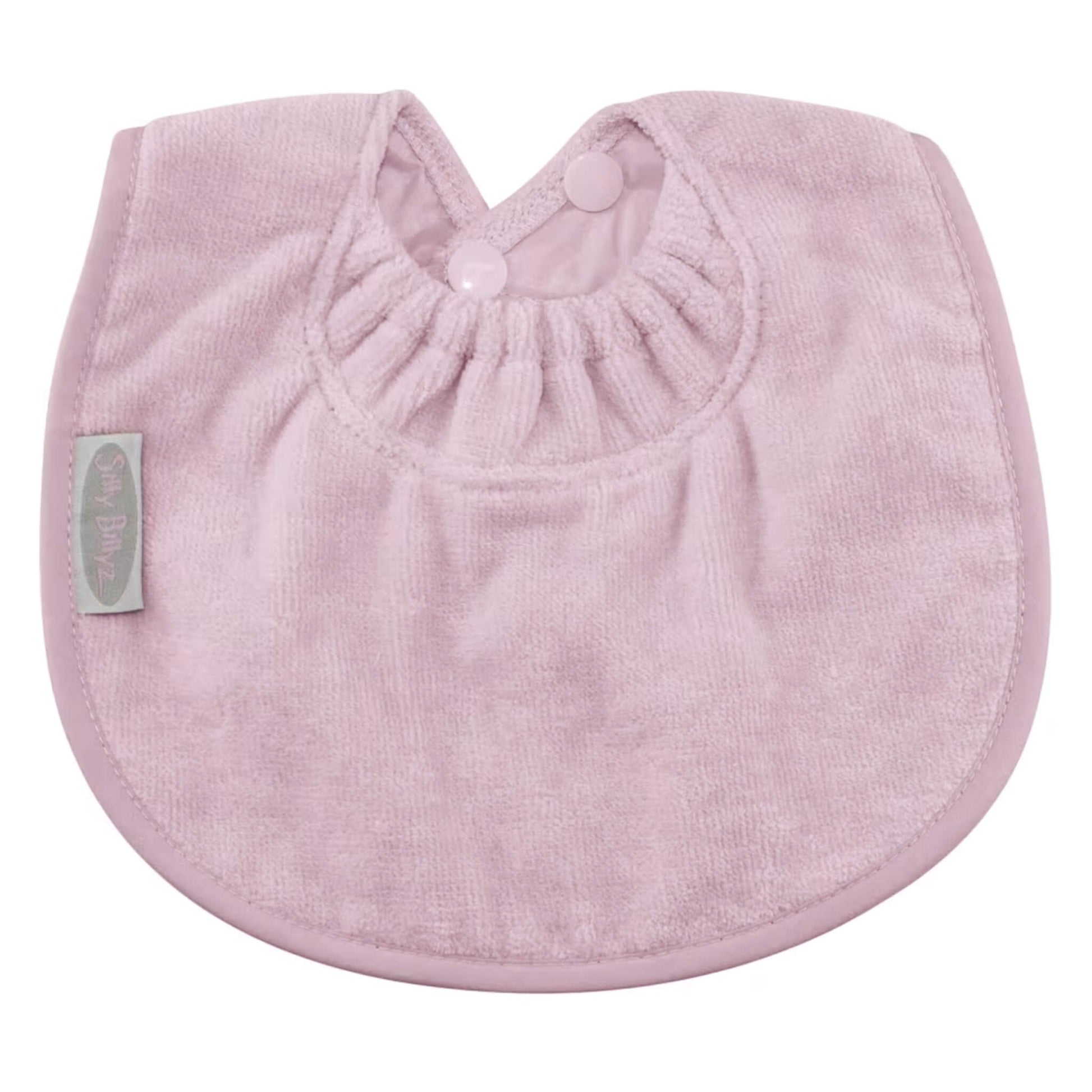 Silly Billyz Towel Biblet in soft pink, made from absorbent towelling with a rounded shape, gentle elasticated neckline, and snap button closure for a comfortable fit on young babies.