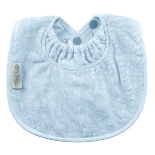 Silly Billyz Towel Biblet in light blue shown with soft towelling front, close-fitting gathered neckline and double snap fastening, designed to sit neatly against a baby’s chest.