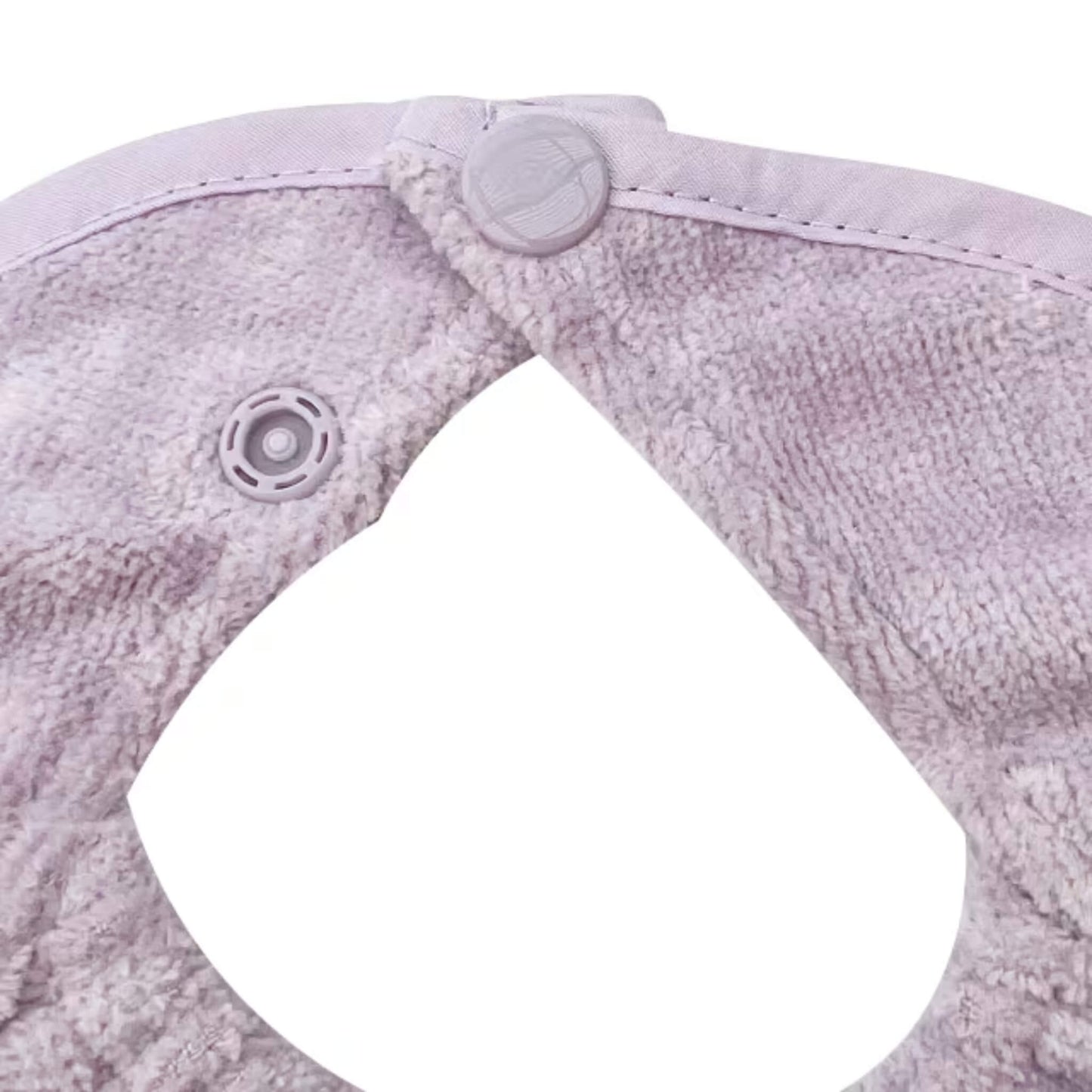 A close-up of a baby dribble bib neckline, showing two adjustable plastic snap fasteners secured through soft towelling fabric.
