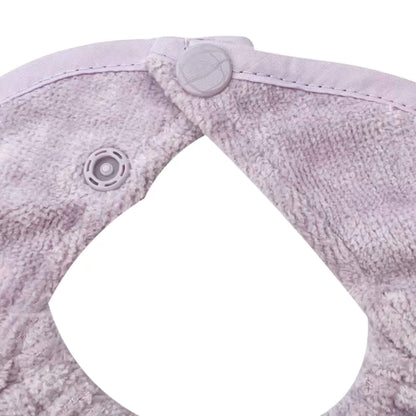 A close-up of a baby dribble bib neckline, showing two adjustable plastic snap fasteners secured through soft towelling fabric.