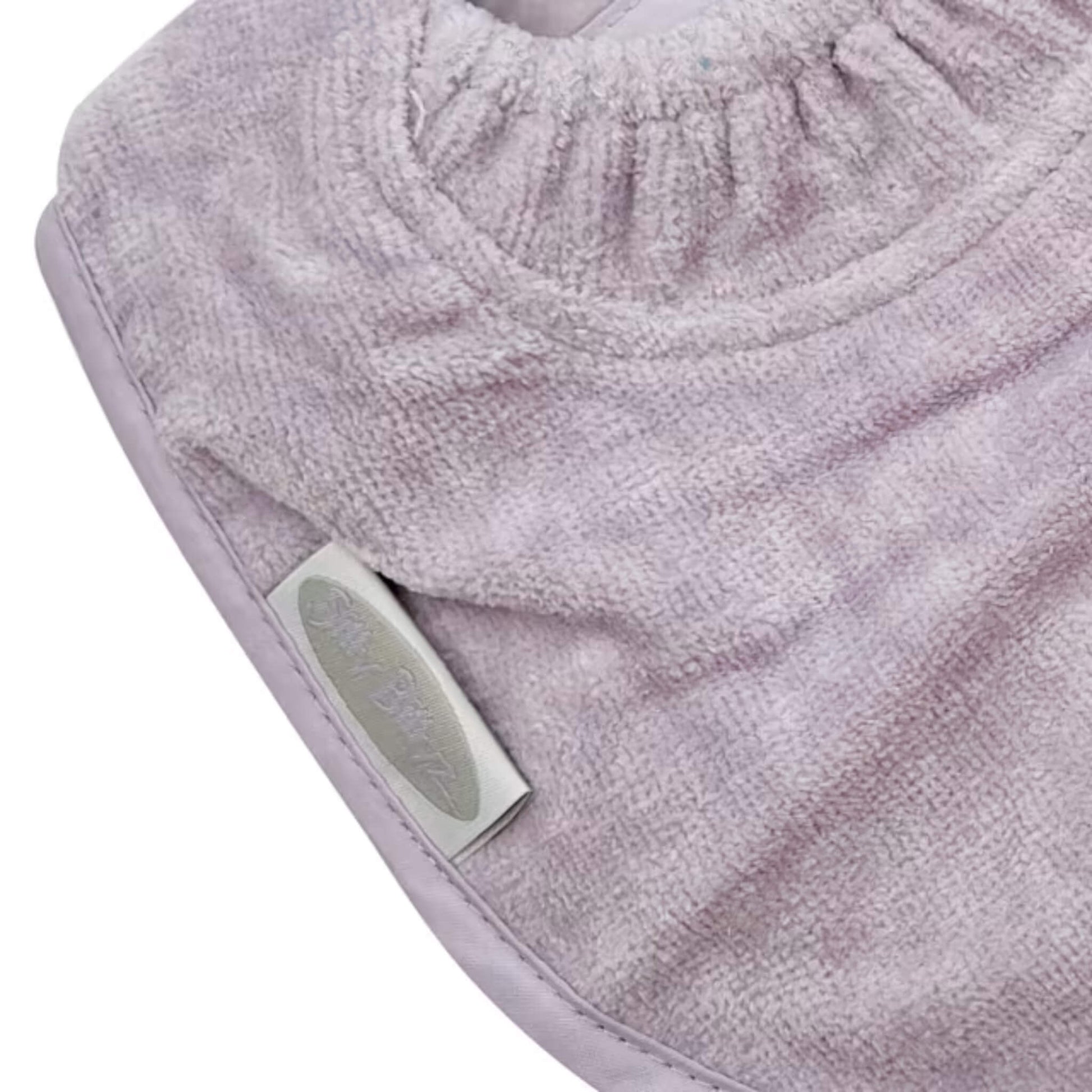 A detailed view of a baby dribble bib made from plush cotton towelling, showing gathered stitching that forms a close-fitting neck guard.