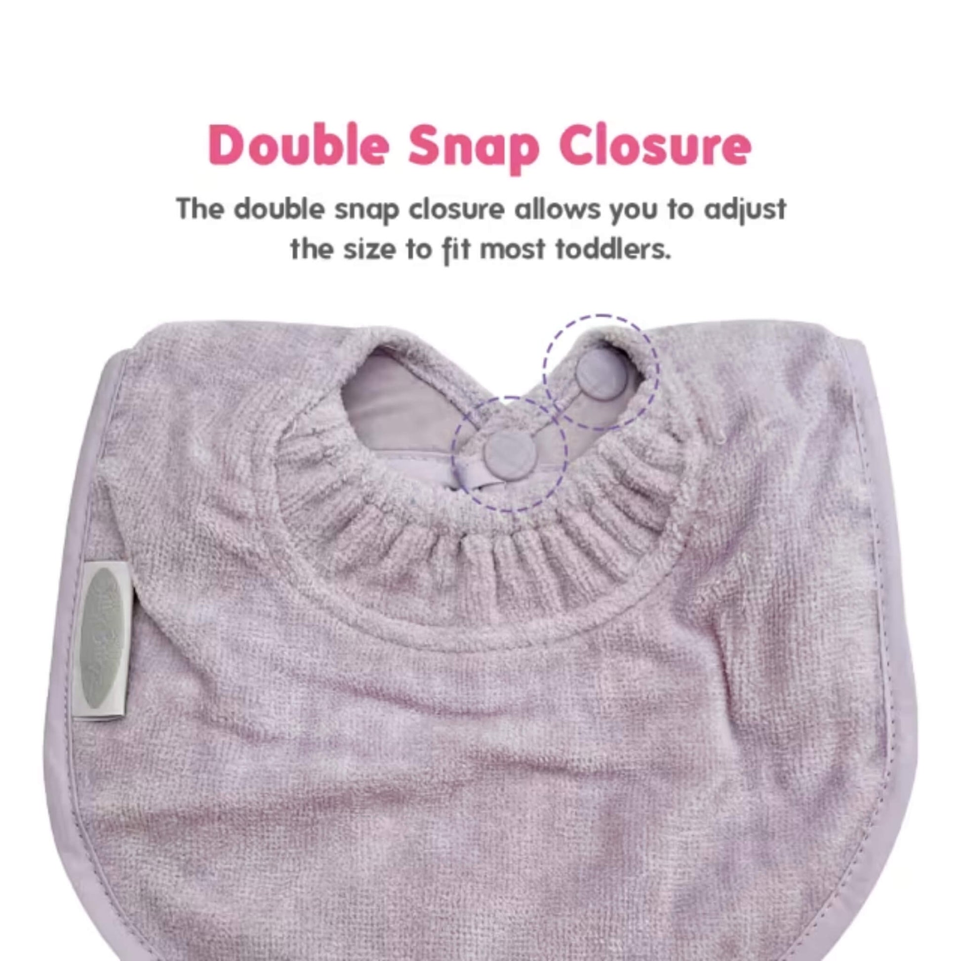 A side view of a baby dribble bib, showing the curved towelling front, stitched binding around the edge, and a small woven brand label sewn into the seam.