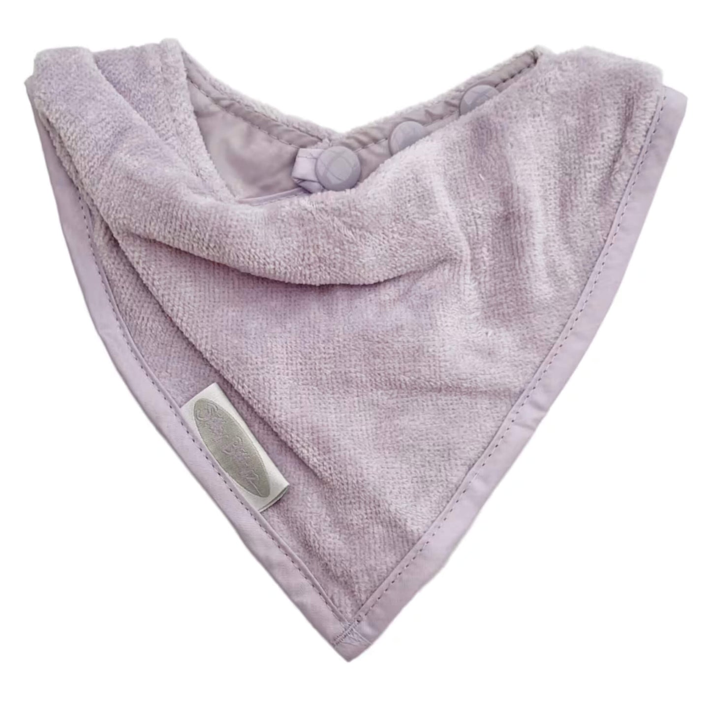 Silly Billyz Towel Bandana Bib shown in a soft lavender velour towelling fabric with a triangular bandana shape and neat stitched edging.