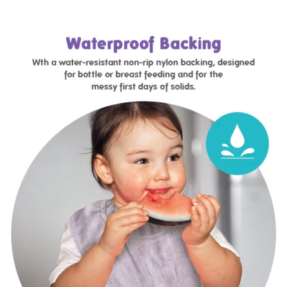 Baby eating fruit while wearing a lavender bib with waterproof backing, demonstrating protection from spills during early solid feeding.