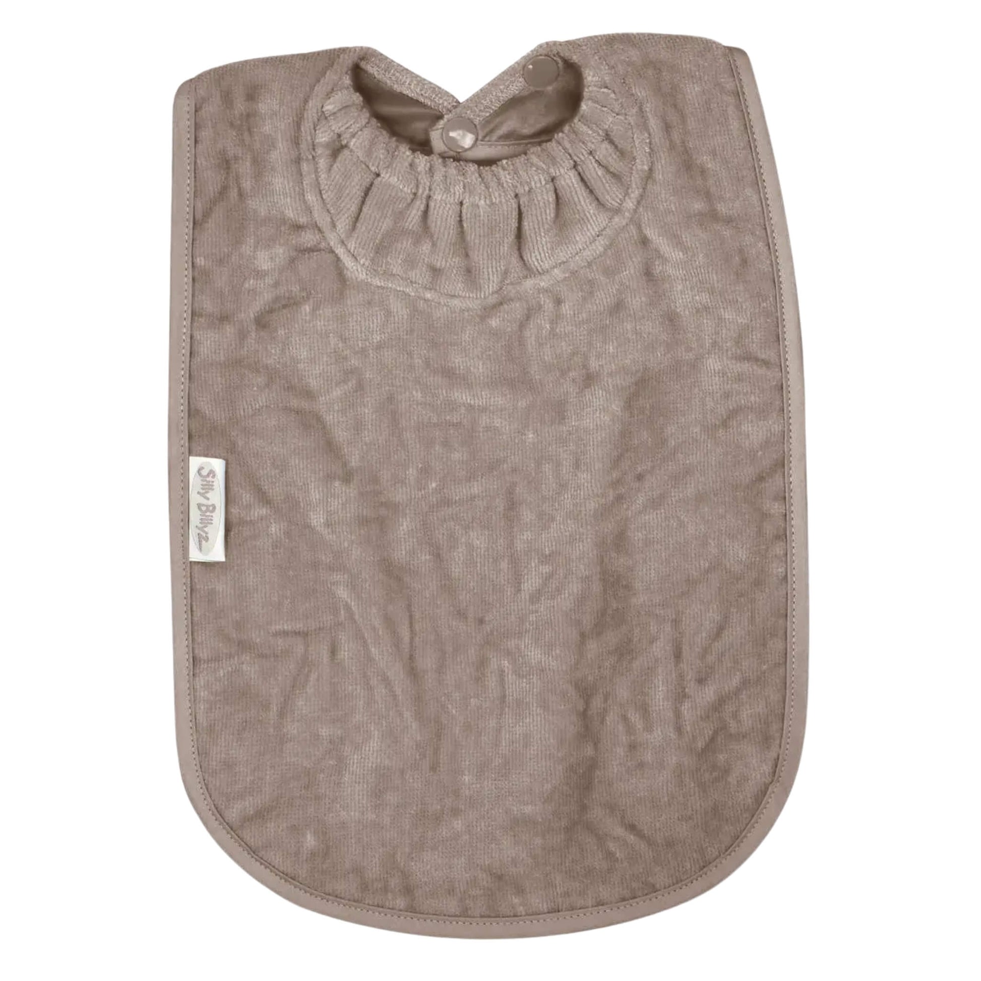 A Silly Billyz Towel XL Bib in taupe shown laid flat, with a long towelling front, rounded edges and an elasticated neckline with snap fasteners.