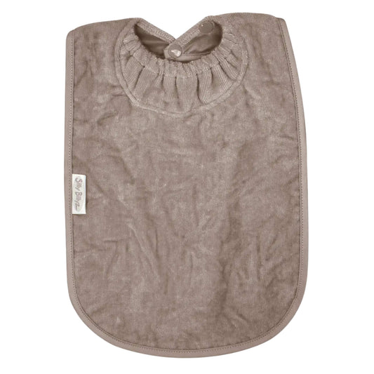 A Silly Billyz Towel XL Bib in taupe shown laid flat, with a long towelling front, rounded edges and an elasticated neckline with snap fasteners.