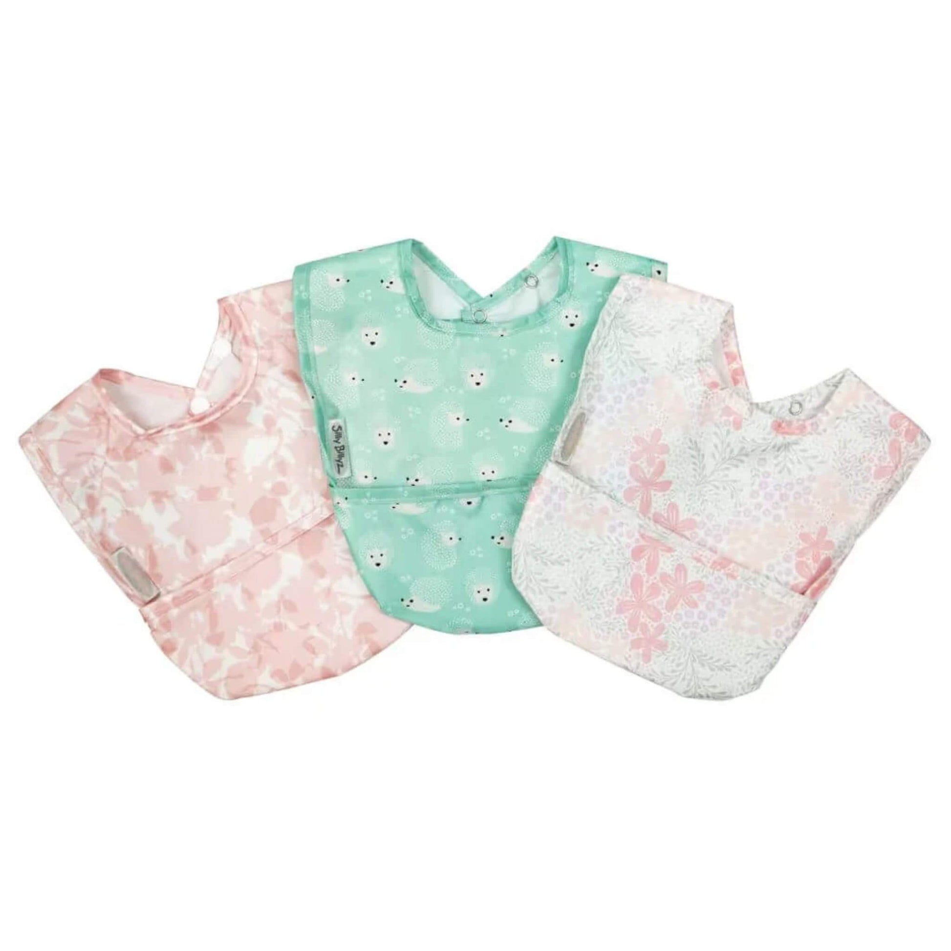 Silly Billyz wipe clean pocket bib 3 pack in varying designs, shown laid flat with soft waterproof fabric, curved shape, and front food-catching pockets.