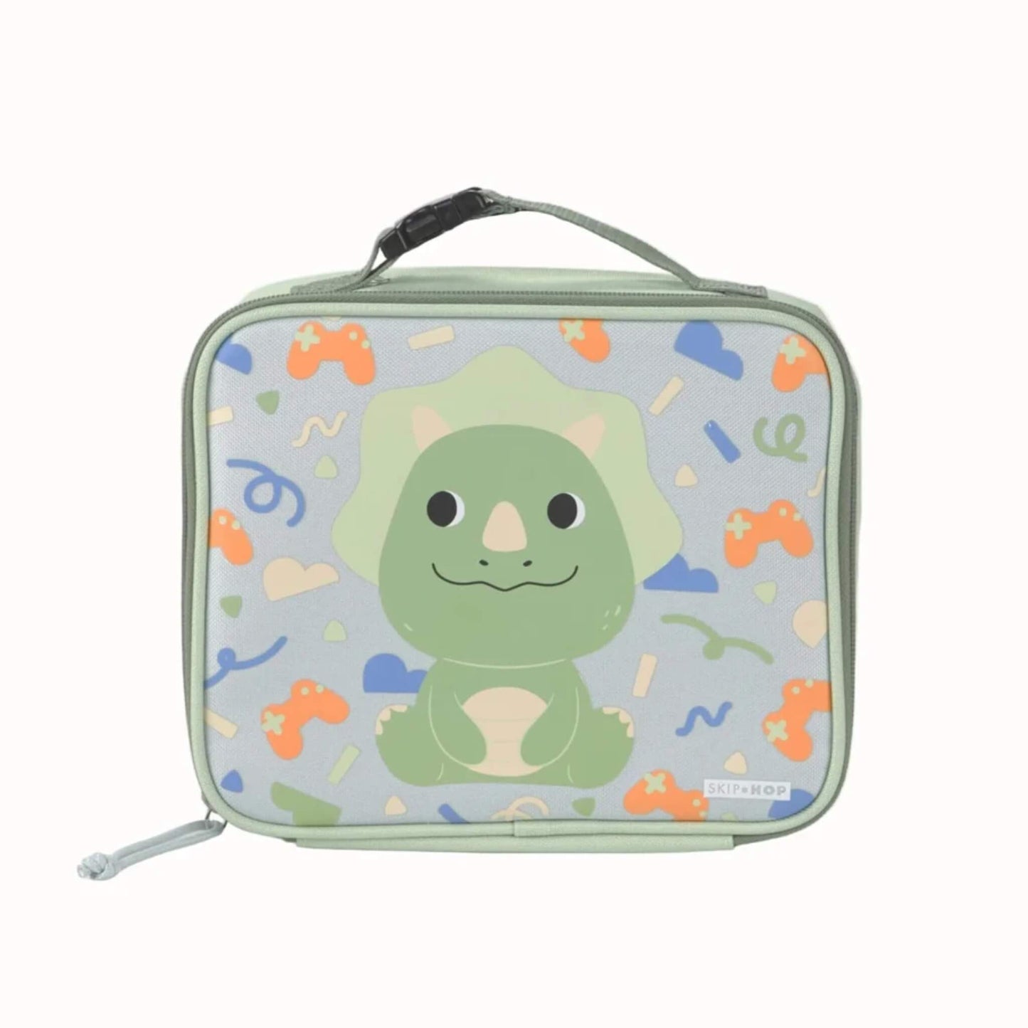 A rectangular zippered lunch bag with a light green handle and zipper, featuring a cartoon Triceratops dinosaur on a light blue background with confetti motifs. The brand name 'SKIP HOP' is visible on a small tag near the bottom right.