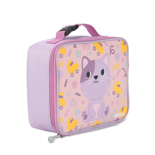 A light purple childrens lunch bag with a pink zipper and handle, featuring a cute cartoon cat design on the front. The bag has a small visible 'SKIP HOP' brand label in the bottom right corner and is photographed on a clean white background.