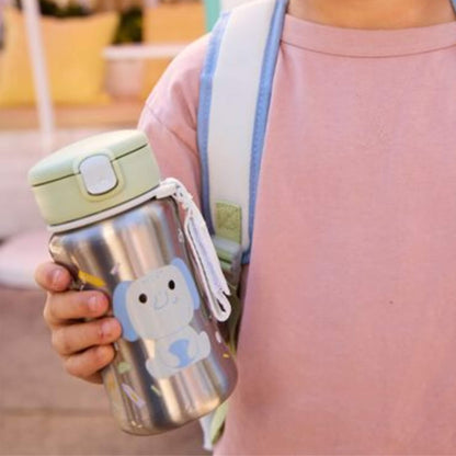 A child wearing a pink T-shirt and backpack holds a silver elephant character kids water bottle by their side, showing its compact size and attached carry strap.
