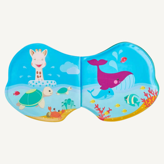 Open waterproof baby bath book showing illustrated ocean scenes with whales, turtles, fish, coral and bubbles across two joined pages.
