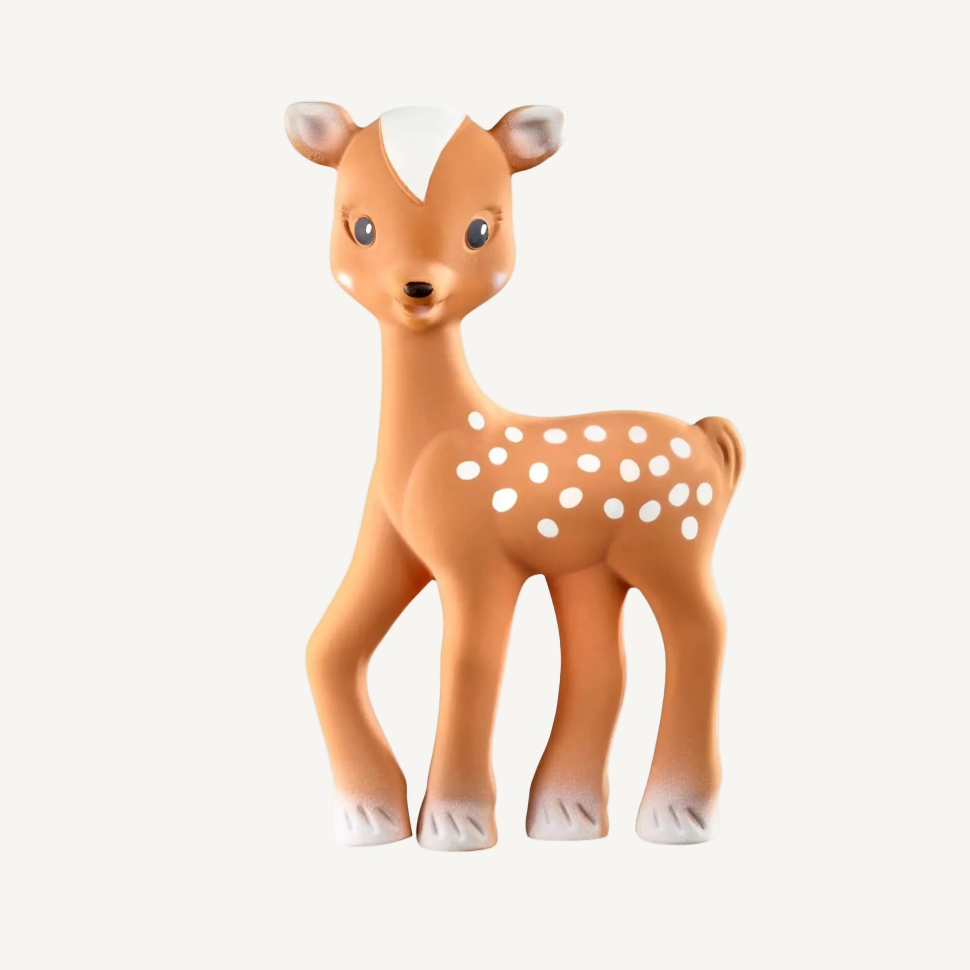 A natural rubber fawn-shaped baby teething toy standing upright, with a warm brown body, white spotted markings, and gently curved legs.