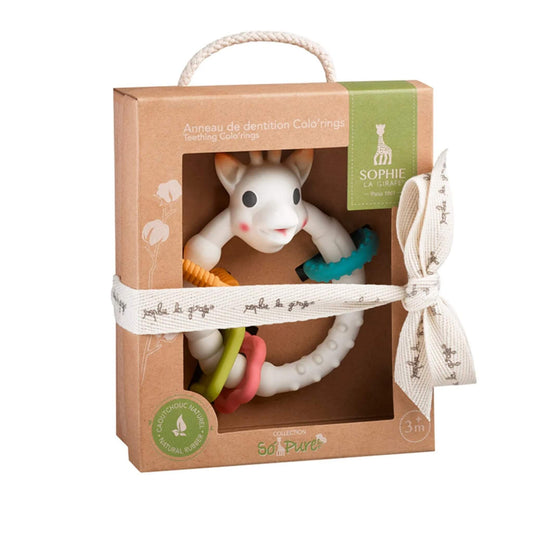Sophie la Girafe So’Pure multi-textured teething rings toy displayed in a recyclable brown cardboard gift box with rope handle, fabric ribbon tie, and colourful textured rings visible.