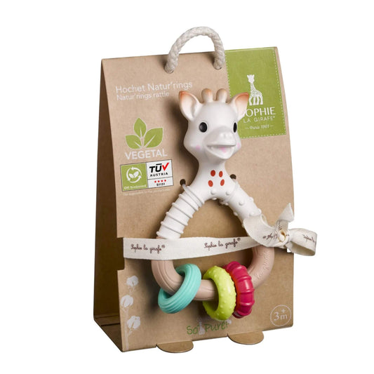 Sophie la Girafe So’Pure Natur’rings rattle teether displayed in recyclable cardboard packaging with rope handle, fabric ribbon tie, and three colourful textured rings.