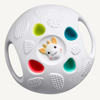 Textured white sensory ball with raised grip panels, colourful soft-touch sections, and small giraffe face detail at the centre.