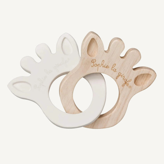 Two giraffe-shaped silhouette teething rings, one made from natural rubber and one from smooth rubberwood, linked together.